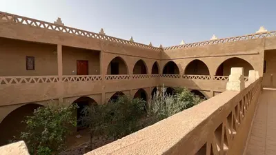 a stone bridge with arches in a building at Hotel Riad Oasis in Merzouga
