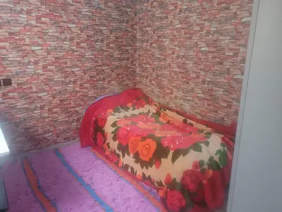 a bedroom with a bed in a brick wall at بيت مع وجبة إفطار لمشجعي كأس الأمم الأفريقية in Fès