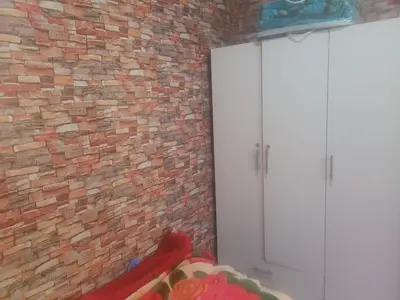 a room with a brick wall and a white door at بيت مع وجبة إفطار لمشجعي كأس الأمم الأفريقية in Fès