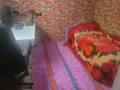 a bedroom with a bed on a pink rug at بيت مع وجبة إفطار لمشجعي كأس الأمم الأفريقية in Fès
