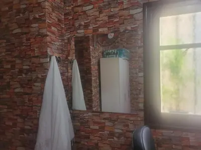 a mirror on a brick wall with a surfboard at بيت مع وجبة إفطار لمشجعي كأس الأمم الأفريقية in Fès