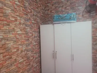 a brick wall with a white cabinet and a door at بيت مع وجبة إفطار لمشجعي كأس الأمم الأفريقية in Fès