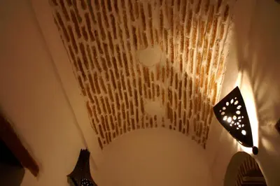 a chandelier hanging from a ceiling in a room at Riad Felloussia in Meknès