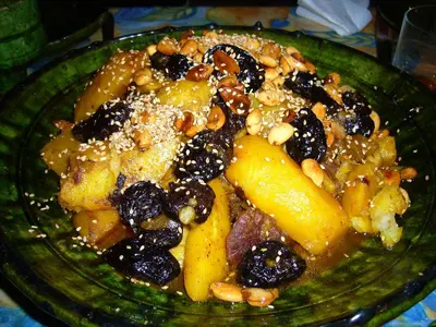 a green plate of food with fruit and nuts at Le Drom'blanc in Mhamid