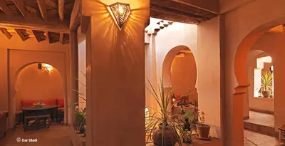 a hallway of a house with a table and a light at Dar Bladi in Ouarzazate