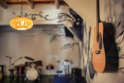 a guitar hanging from a wall in a room at Ksar Ighnda in Aït Ben Haddou