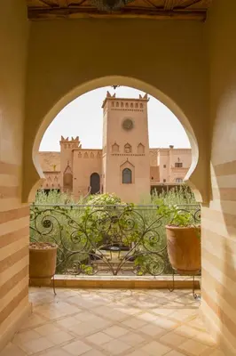 an archway leading to a building with a clock tower at Ksar Ighnda in Aït Ben Haddou