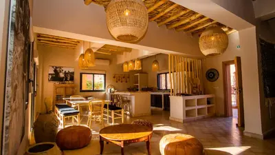 a living room with a table and chairs at Ksar Ighnda in Aït Ben Haddou