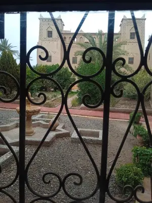 an iron gate with a view of a building at Dar Es Salam in Skoura