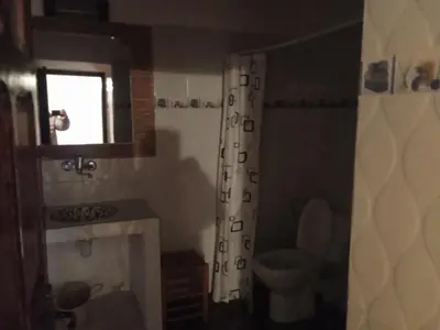 a bathroom with a toilet and a shower curtain at Dar Es Salam in Skoura