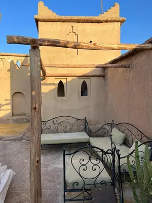 a bed on the side of a building at Dar Es Salam in Skoura