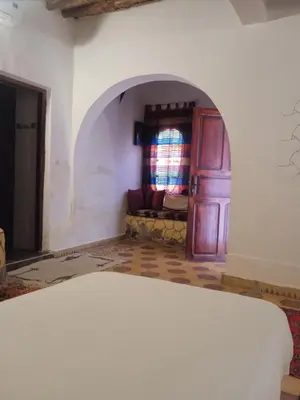 a living room with a door and a couch at Dar Es Salam in Skoura