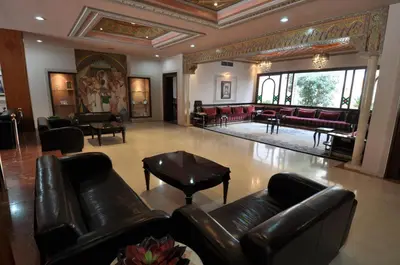 a lobby with leather couches and a living room at Hôtel Wassim in Fès