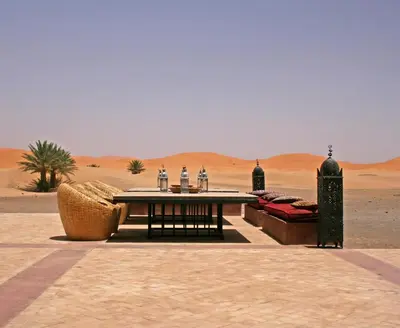 a table in the middle of the desert at Kanz Erremal in Merzouga