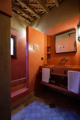 a bathroom with a sink and a mirror at Kanz Erremal in Merzouga