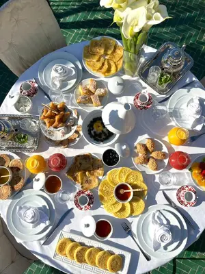 a table with many plates of food on it at Dar Tazi - Medina View in Fès