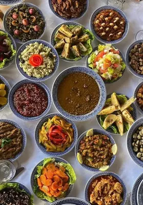 a table full of bowls of different types of food at Dar Tazi - Medina View in Fès