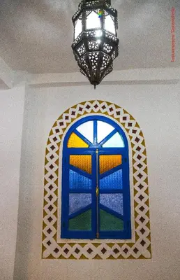 a blue window in a room with a chandelier at Hotel Riad Sahara Activity in Mhamid