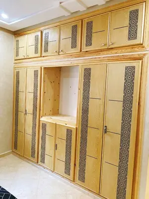 a room with wooden lockers in a room at Appartement calme in Fès