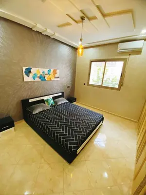 a bedroom with a large bed in a room at Appartement calme in Fès