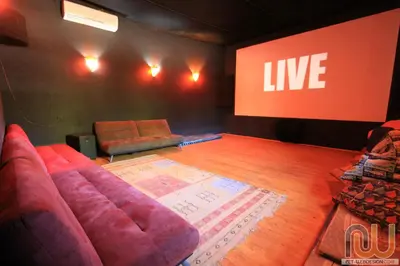a stage with a couch in front of a screen at La Perle Du Dades in Boumalne