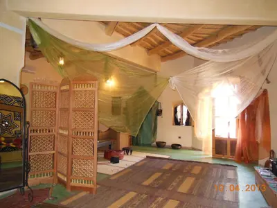 a room with a tent in the middle of a room at La Perle Du Dades in Boumalne