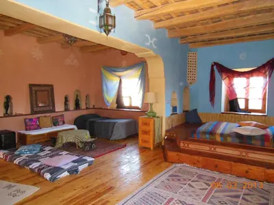 a bedroom with two beds in a room at La Perle Du Dades in Boumalne