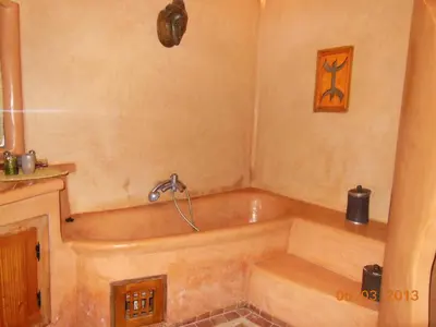 a bath tub in a bathroom with at La Perle Du Dades in Boumalne