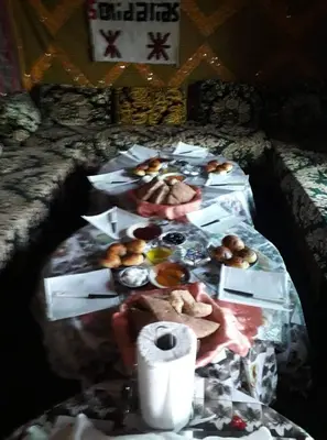 a table with a bunch of donuts on it at Auberge Ouabas in Agoudim
