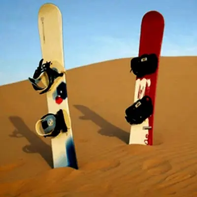 two snowboards stuck in the sand in the desert at Merzouga heart camp in Merzouga
