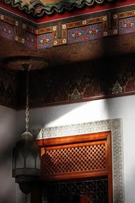 a room with a wooden ceiling and a chandelier at Riad Alya in Fès