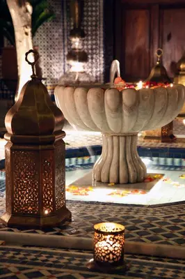 a large white fountain with a candle in a room at Riad Alya in Fès