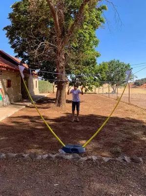 a girl standing in front of a tree with a kite at Chalet nina in Azrou