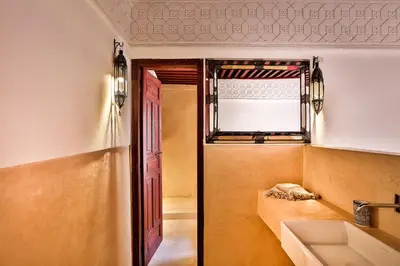 a room with a couch and a window and a sink at Hotel & Spa Dar Bensouda in Fès