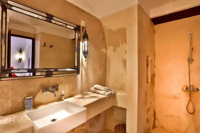 a bathroom with a sink and a mirror at Hotel & Spa Dar Bensouda in Fès