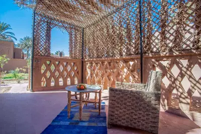 a gazebo with a table and chairs on a patio at Chez Le Pacha - Authentic Sahara Hotel Mhamid in Mhamid