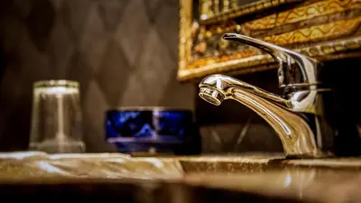 a bathroom sink with a blue cup next to aaucet at Chez Le Pacha - Authentic Sahara Hotel Mhamid in Mhamid