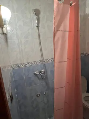 a bathroom with a shower with a curtain and a toilet at Chez ZAKi in Meknès