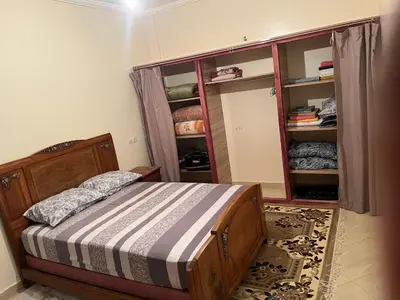 a bedroom with a bed and a book shelf at Chez ZAKi in Meknès