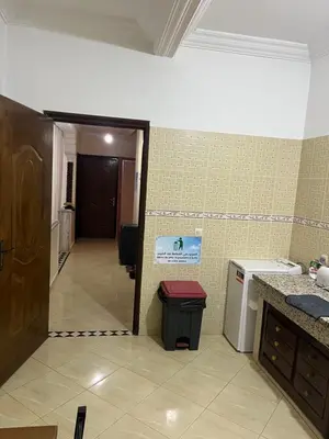 a hallway of a kitchen with a door and a trash can at Chez ZAKi in Meknès