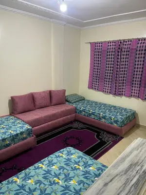 a living room with a couch and two ottomans at Chez ZAKi in Meknès