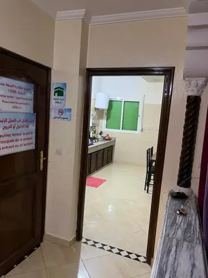 a room with a door leading to a kitchen at Chez ZAKi in Meknès