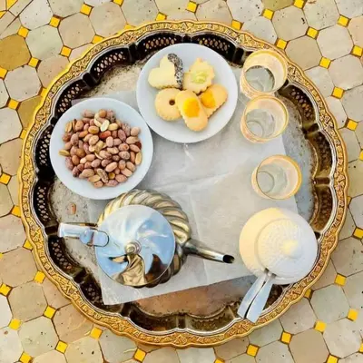 a table with plates of food and bowls of food at Maktub Desert Luxury Camp in Merzouga