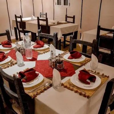 a table with plates of food on top at Maktub Desert Luxury Camp in Merzouga