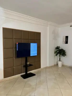 a room with a flat screen tv on a wall at Appartement à beni mellal in Beni Mellal