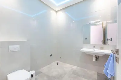 a white bathroom with a sink and a toilet at Villa Coquelicot, modern style avec jacuzzi, piscine Chauffée in Marrakech