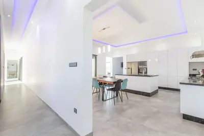 a kitchen and dining room with a table and chairs at Villa Coquelicot, modern style avec jacuzzi, piscine Chauffée in Marrakech
