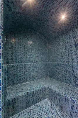 a blue tiled shower with two lights in a room at Villa Coquelicot, modern style avec jacuzzi, piscine Chauffée in Marrakech