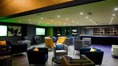 a waiting room with colorful chairs and tables at HOTEL BELLE VUE MEKNES in Meknès