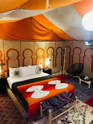a bedroom with a bed in a tent at Glance over nights at luxury in Merzouga